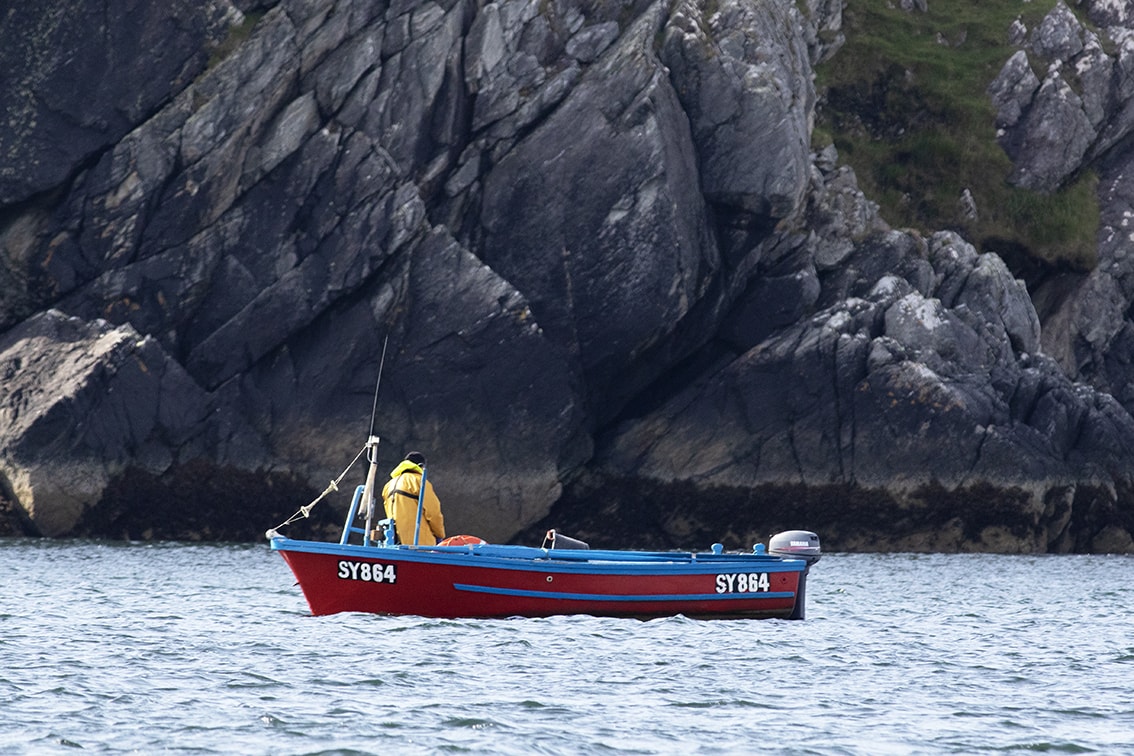 Fishermen working on the coast of the Isle of Lewis